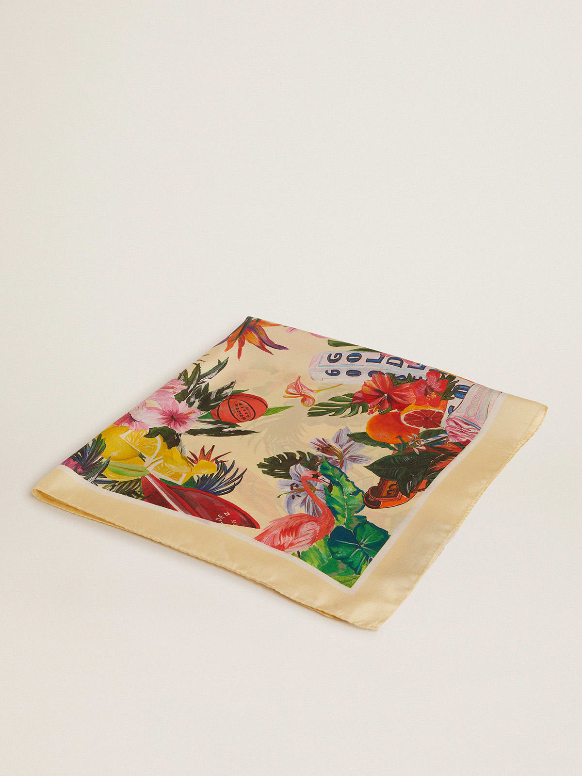 Lemonade-colored silk scarf with multicolored tropical print