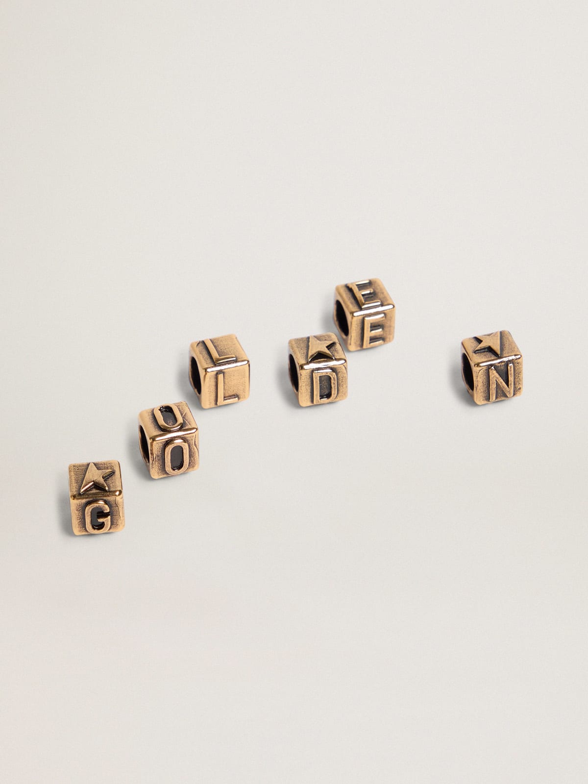 Messages Jewelmates Collection cubic charms in old gold color with letters of the alphabet