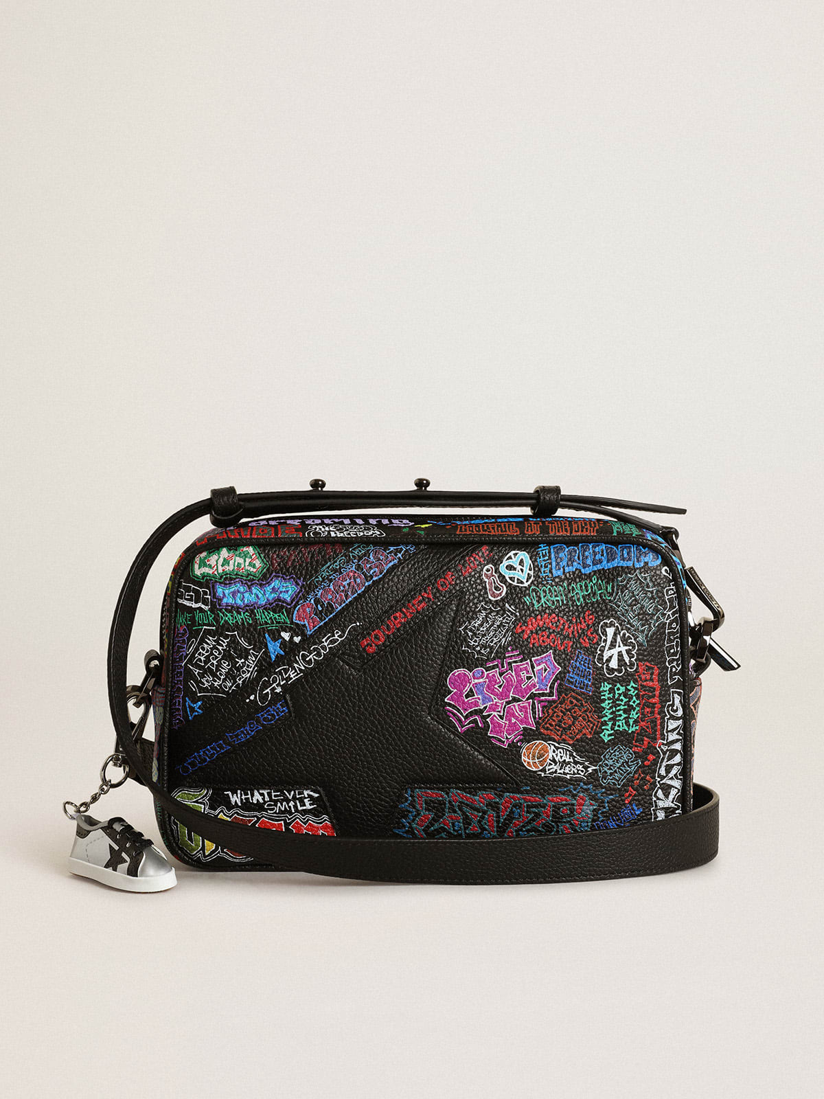 Star Bag in black hammered leather with black leather star and all-over multicolored print