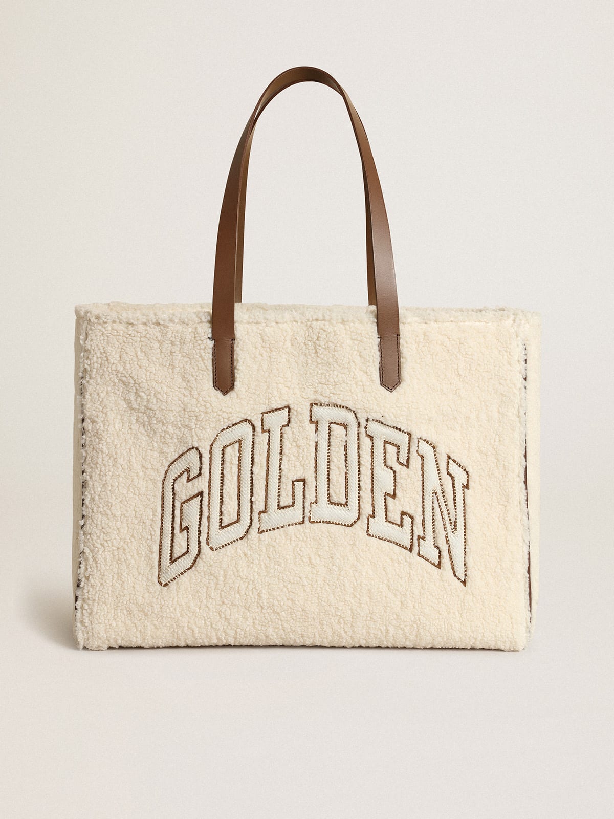 East-West California Bag in white faux fur with Golden lettering and contrasting handles