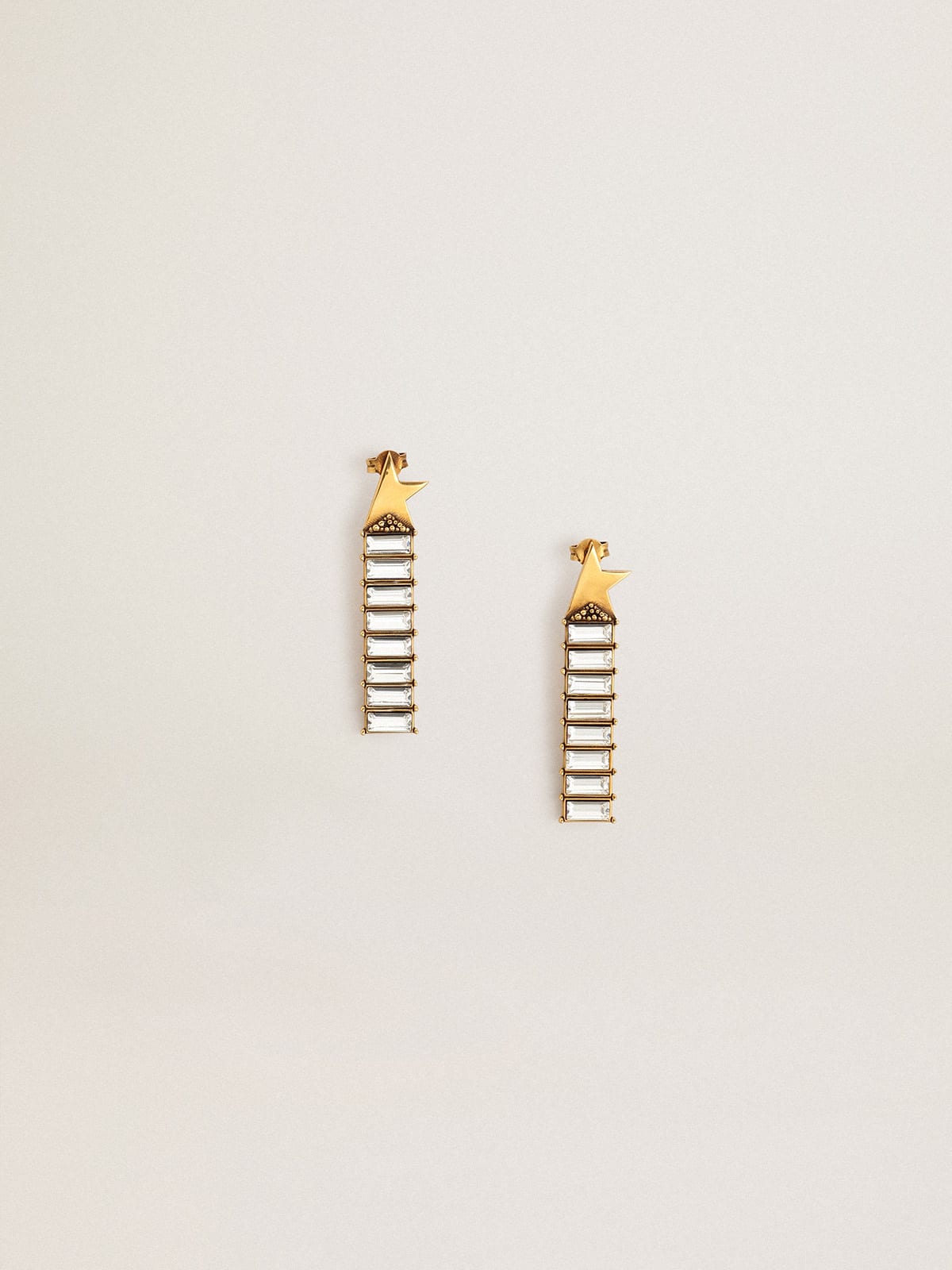 Drop earrings with old gold star and baguette-shaped crystals