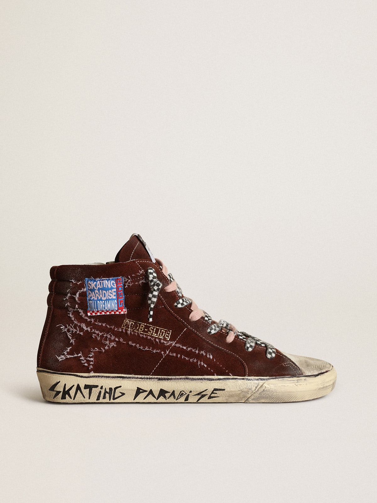 Slide sneakers in chocolate-colored suede with white stitching on the star and flash