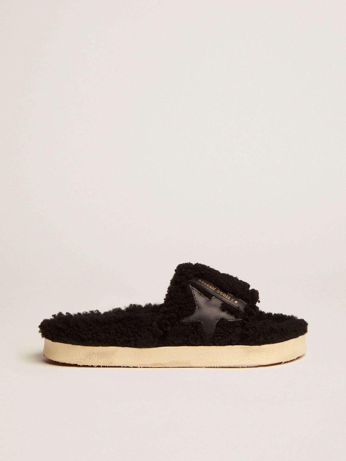 Poolstars in black shearling with star in tone-on-tone leather